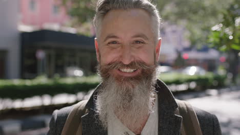 portrait-of-mature-sophisticated-bearded-man-smiling-cheerful-optimistic-on-city-street