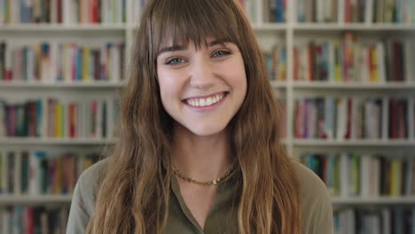 close-up-portrait-of-young-pretty-librarian-woman-smiling-happy-looking-at-camera-in-library-bookshelf-background