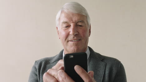 close-up-of-senior-businessman-using-phone-portrait-of-professional-entrepreneur