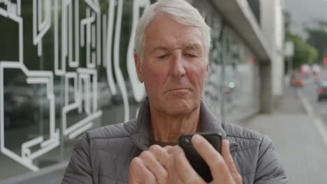 portrait-of-midde-aged-caucasian-man-using-smartphone-texting-browsing-online-sending-sms-message-on-mobile-phone-technology-app-on-urban-city-street