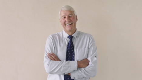 portrait-of-elderly-businessman-happy-laughing-arms-crossed-retirement