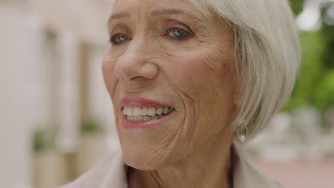 close-up-portrait-of-elegant-elderly-woman-looking-happy-enjoying-sightseeing-in-urban-city-background