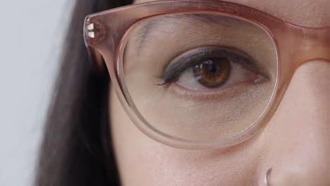 close-up-young-woman-eye-looking-at-camera-blinking-wearing-stylish-glasses
