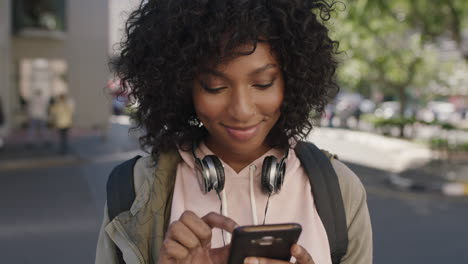 portrait-of-young-attractive-african-american-woman-texting-browsing-using-smartphone-relaxed-casual-urban-travel
