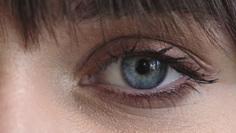 close-up-young-woman-blue-eye-blinking-looking-at-camera