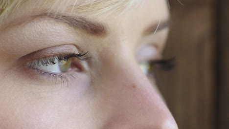 close-up-of-young-woman-eyes-looking-pensive-contemplative-out-window