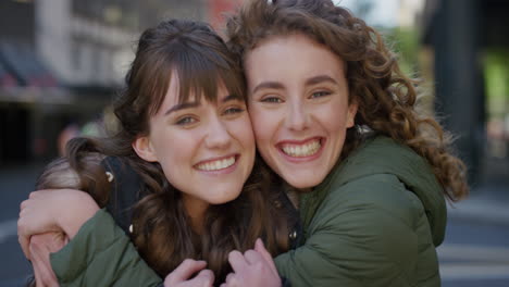 portrait-young-woman-surprise-kiss-girlfriend-hugging-smiling-cheerful-couple-enjoying-frienship-best-friends-embracing-having-fun-in-urban-city-street-real-people-series