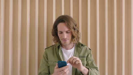 portrait-of-handsome-young-caucasian-man-texting-browsing-online-using-smartphone-mobile-technology-enjoying-digital-communication