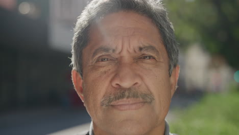 close-up-portrait-of-middle-aged-hispanic-man-looking-serious-in-sunny-urban-city-background
