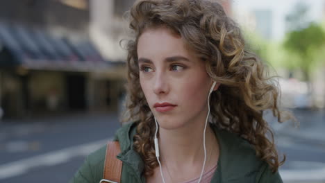portrait-of-beautiful-woman-waiting-on-city-street-sad-unhappy-wearing-earphones-listening-to-music-young-caucasian-female-thinking-contemplative-in-urban-background