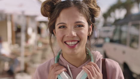 portrait-of-young-beautiful-hispanic-woman-smiling-happy-on-sunny-beachfront-wearing-headphones