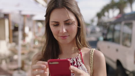 portrait-of-young-brunette-woman-using-smartphone-texting-on-vacation
