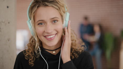 portrait-of--blonde-woman-college-student-wearing-headphones-enjoying-listening-to-music-dancing-playful-fun-recreation-entertainment