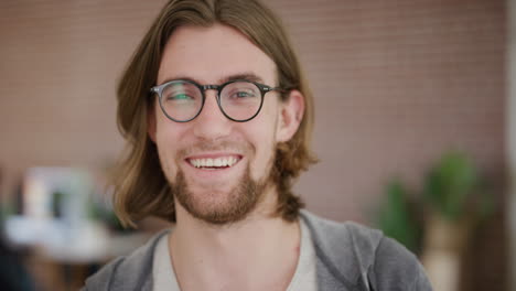 close-up-portrait-of-handsome-young-man-laughing-happy-enjoying-success-geek-wearing-glasses-looking-at-camera-real-people-series