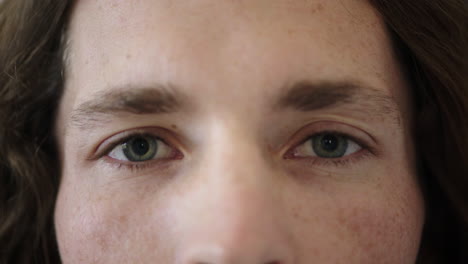 close-up-of-man-blue-eyes-opening-caucasian-male-awake-looking-at-camera-watching-iris-focus-face-freckles