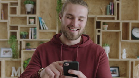 close-up-of-attractive-cheerful-young-man-enjoying-texting-browsing-using-smartphone-feeling-connected