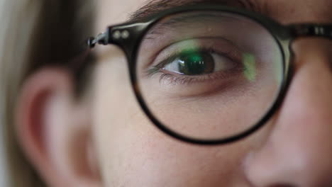 close-up-of-young-man-eye-opening-wearing-glasses-looking-happy-healthy-eyesight-concept