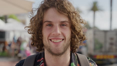 close-up-portrait-of-happy-young-man-smiling-enjoying-warm-summer-vacation-in-busy-urban-beachfront-real-people-series