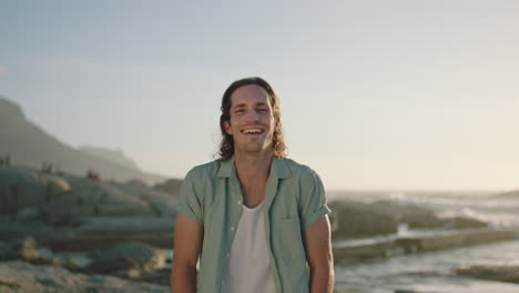 portrait-of-attractive-young-man-laughing-by-beach-sunset-ocean