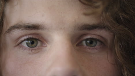close-up-of-man-beautiful-blue-eyes-opening-caucasian-male-awake-looking-at-camera-watching-iris-focus