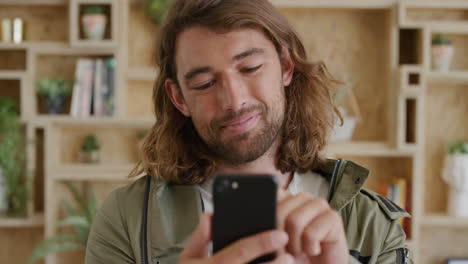 close-up-portrait-of-young-man-student-using-smartphone-texting-browsing-enjoying-reading-online-social-media-messages-smiling-slow-motion