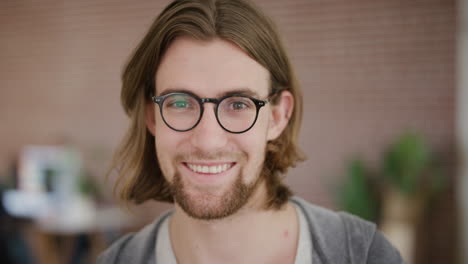 close-up-portrait-of-handsome-young-man-smiling-happy-enjoying-success-geek-wearing-glasses-looking-at-camera-real-people-series
