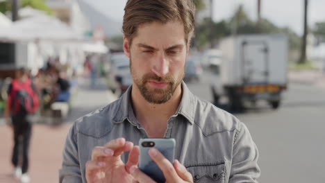 portrait-of-attractive-young-man-using-smartphone-texting-browsing-enjoying-mobile-communication-satisfaction-checking-messages-on-sunner-urban-beachfront-slow-motion