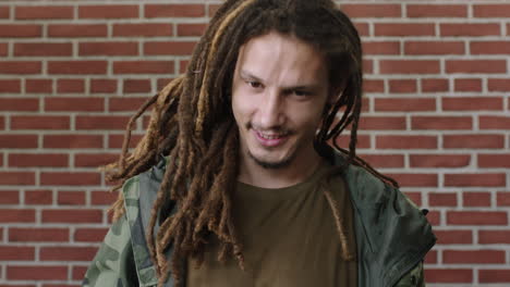 portrait-of-attractive-young-mixed-race-man-with-dreadlocks-smiling-happy-looking-relaxed-at-camera