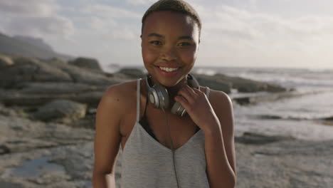 close-up-of-young-woman-laughing-cheerful-wearing-headphones-at-beach-sunny-seaside