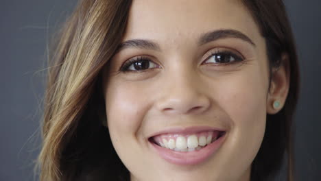 close-up-portrait-beautiful-young-hispanic-girl-smiling-cheerful-enjoying-success-satisfaction-running-hand-through-hair-looking-at-camera