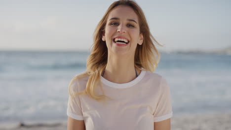 close-up-portrait-of-lovely-blonde-woman-laughing-playful-sunny-day-at-beach