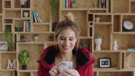 portrait-of-lovely-young-woman-using-smartphone-texting-browsing-wearing-red-jacket-smiling-happy