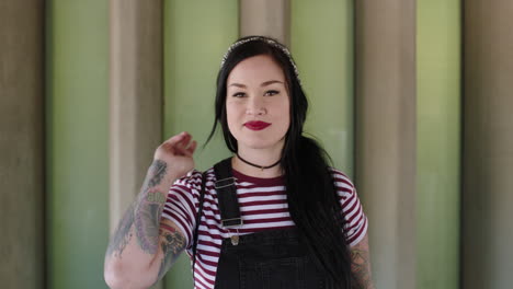 portrait-of-beautiful-young-woman-with-tattoos-smiling-confident-wearing-stripe-shirt