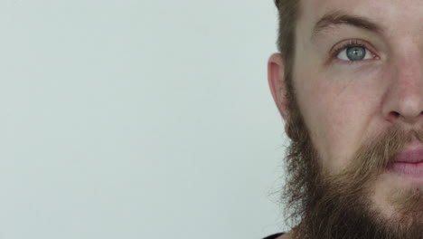 close-up-half-face-of-young-man-hipster-beard-smiling-happy-on-white-background