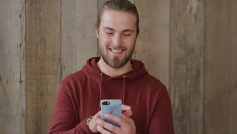 portrait-of-young-man-using-smartphone-texting-browsing-online-enjoying-sending-sms-messages-mobile-communication-smiling-happy-slow-motion
