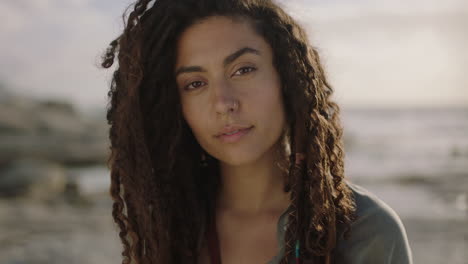 portrait-of-beautiful-independent-hispanic-woman-with-dreadlocks-looking-pensive-thoughtful-at-beach