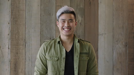 portrait-of-young-handsome-asian-man-cool-hairstyle-smiling-cheerful-looking-at-camera