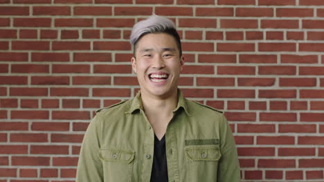 portrait-of-handsome-young-asian-man-laughing-cheerful-at-camera