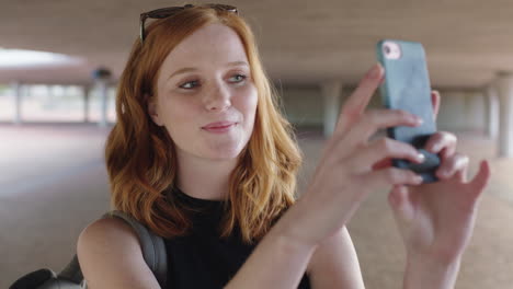 beautiful-young-redhead-woman-portrait-of-happy-student-using-smartphone-taking-selfie-photo