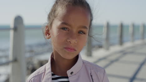 portrait-young-little-mixed-race-girl-looking-serious-contemplative-kid-on-sunny-seaside-beach-slow-motion