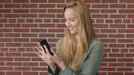 portrait-of-attractive-young-blonde-woman-using-smartphone-smiling-cheerful