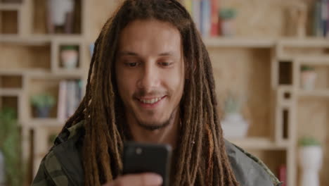 portrait-of-happy-young-mixed-race-man-student-using-smartphone-texting-browsing-online-messages-enjoying-mobile-communication-relaxed-guy-with-dreadlocks