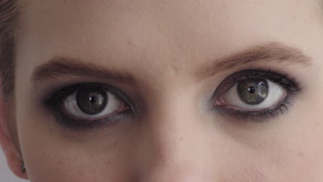 close-up-young-woman-eyes-opening-wearing-makeup-looking-at-camera-beauty-cosmetics