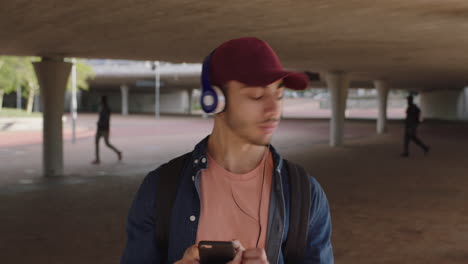 attractive-young-hispanic-man-portrait-of-student-listening-to-music-on-headphones