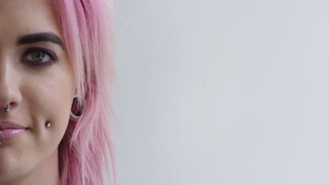 young-punk-woman-portrait-girl-smiling-happy-wearing-piercings-pink-hairstyle-half-face-isolated-on-white-background