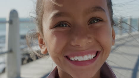 close-up-portrait-young-happy-mixed-race-girl-smiling-enjoying-summer-vacation-on-seaside