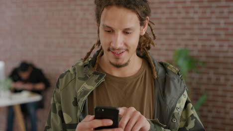 portrait-young-mixed-race-man-student-using-smartphone-browsing-checking-messages-enjoying-online-search-app-in-internet-cafe-dreadlocks-hairstyle