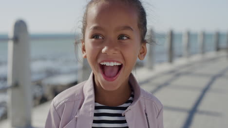 portrait-little-mixed-race-girl-child-laughing-excited-enjoying-beautiful-sunny-day-on-seaside-beach