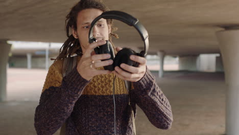 portrait-of-young-mixed-race-man-student-with-dreadlocks-wearing-headphones