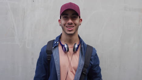 portrait-attractive-young-hispanic-teenage-man-smiling-happy-enjoying-successful-lifestyle-male-student-looking-confident-wearing-hat-slow-motion